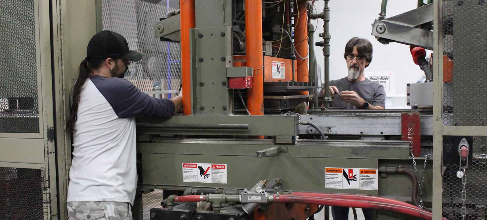 2 men working on trays