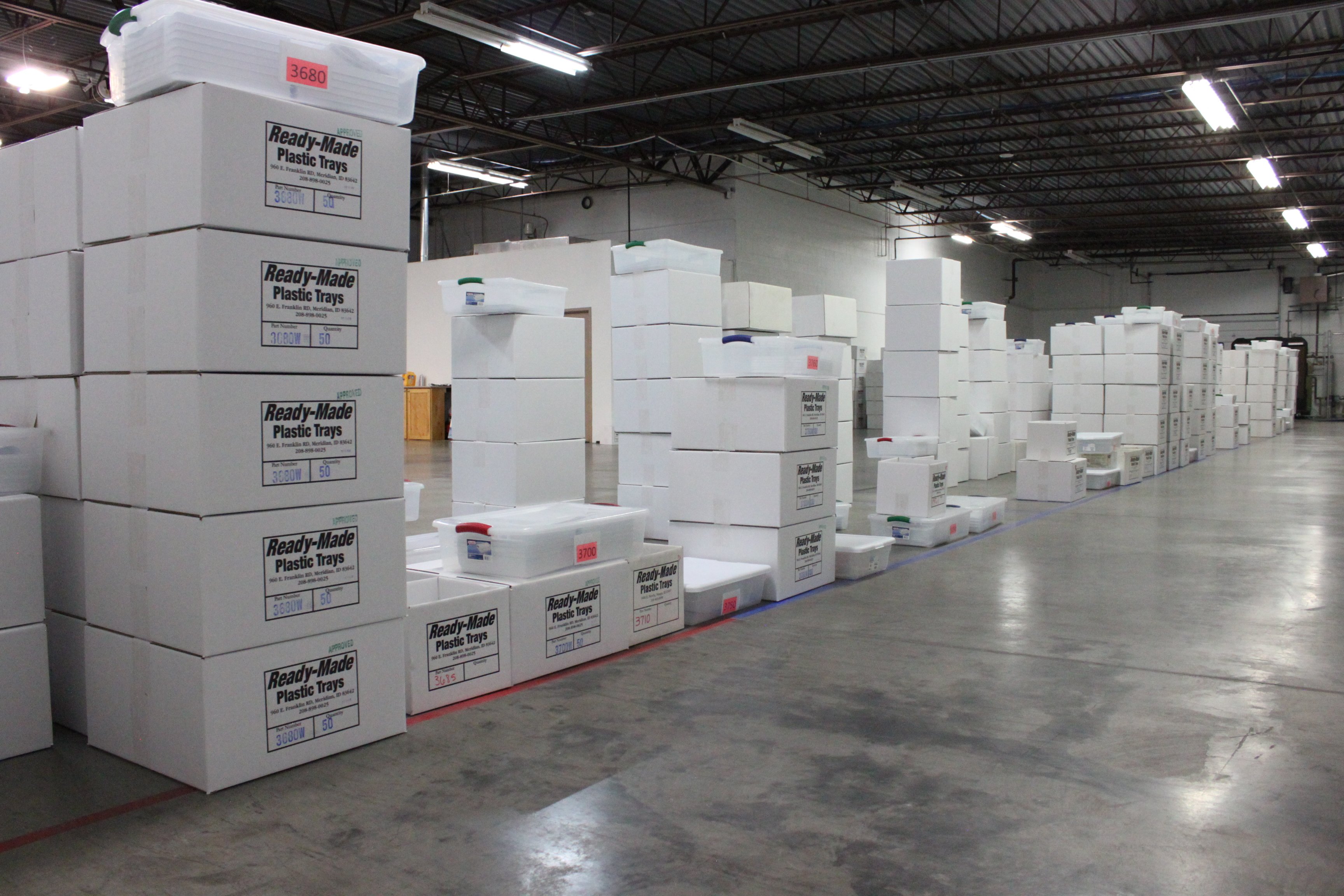 Ready-made boxes containing plastic trays inside a factory