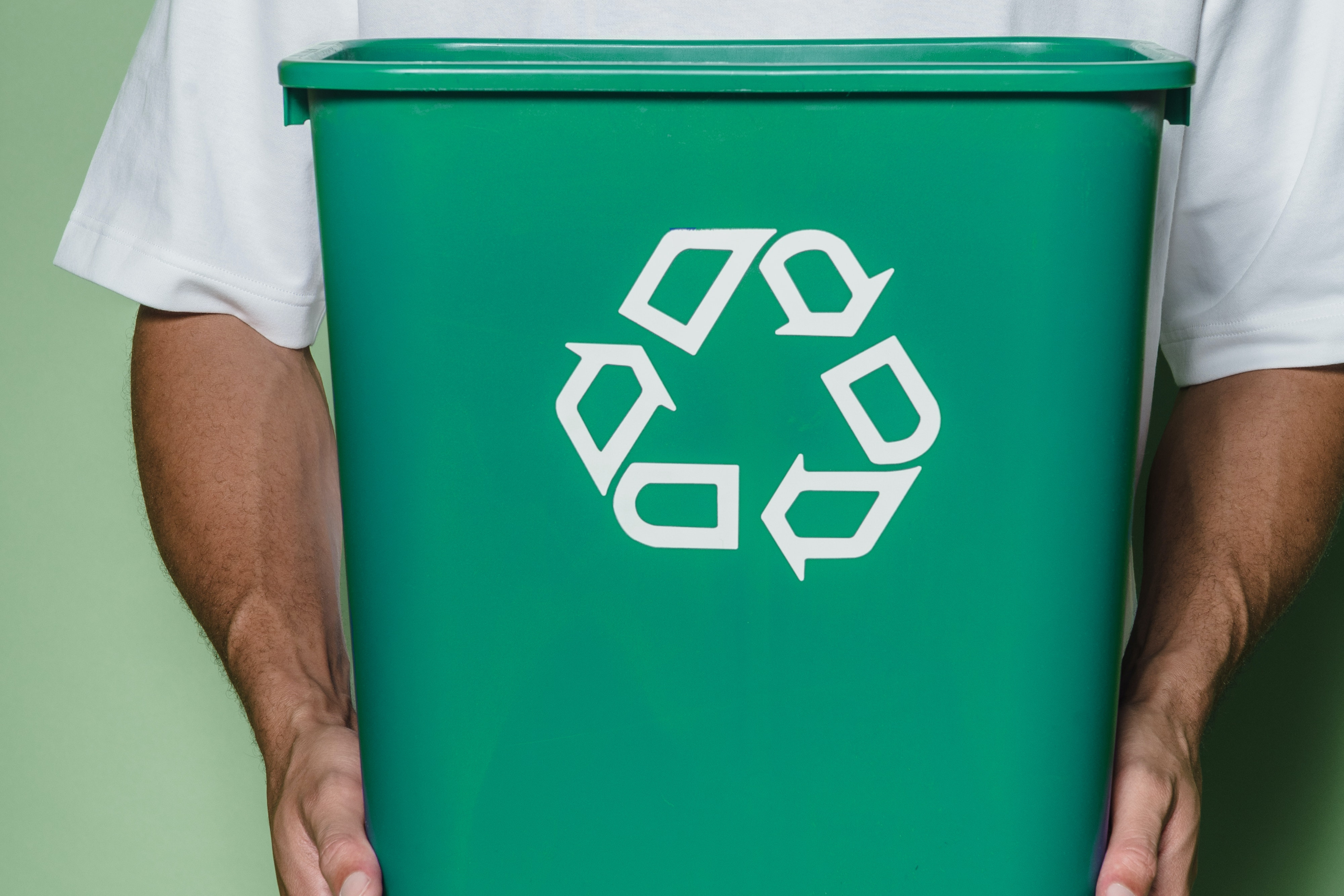 man holding recycling bin